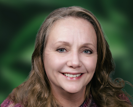 Lori Liberatore is seen here in front of a green and black background.